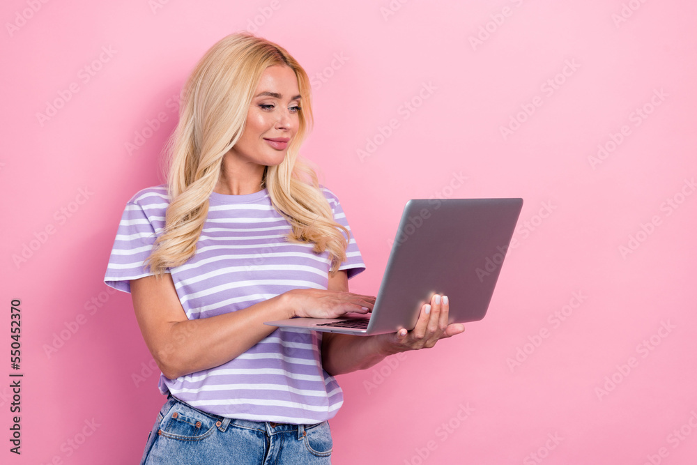 Photo of concentrated lady write email chatting friends choose order online shop empty space isolated on pink color background Photo of concentrated lady write email chatting friends choose order online shop empty space isolated on pink color background