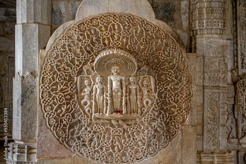 Statues of people on the wall of ranakpur jain temple, India