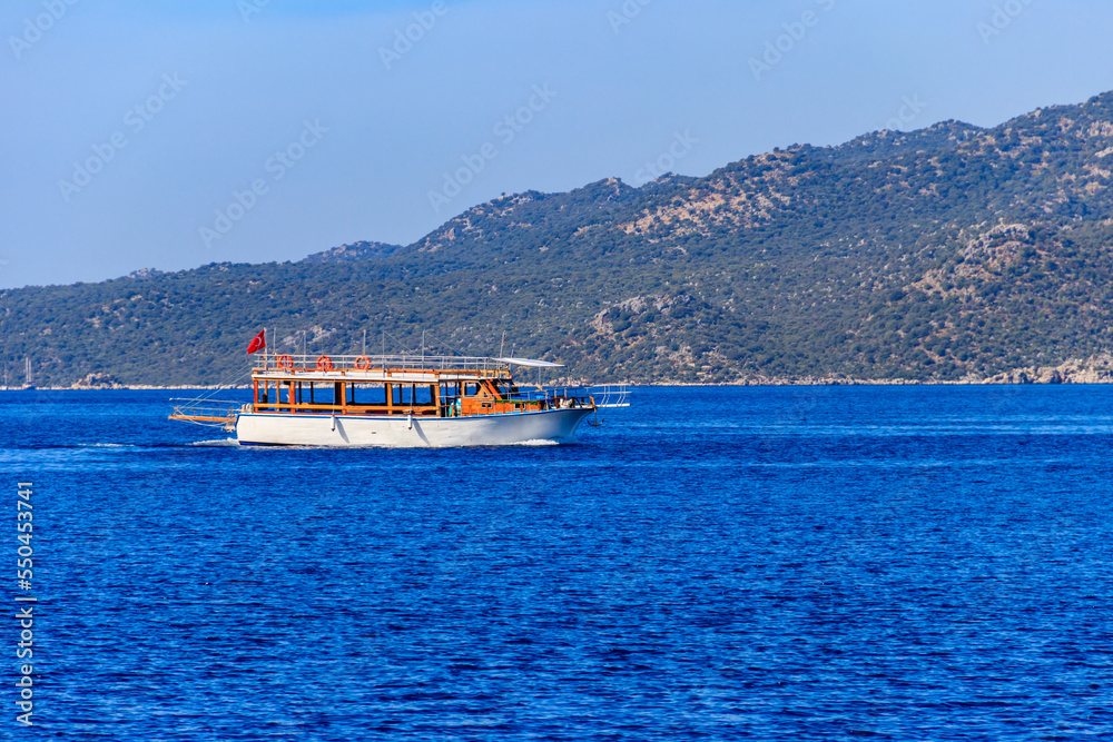 Tourist ship sailing in the Mediterranean sea near Kekova island in Antalya province, Turkey Tourist ship sailing in the Mediterranean sea near Kekova island in Antalya province, Turkey