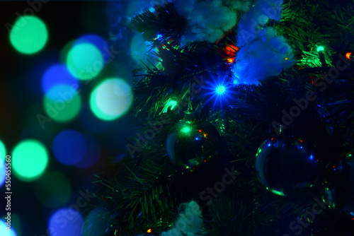 Decorated Christmas tree on a blurred background.Background from a decorated Christmas tree , Greeting card from a Christmas tree with decoration.merry christmas postcard with tree in the foreground.
