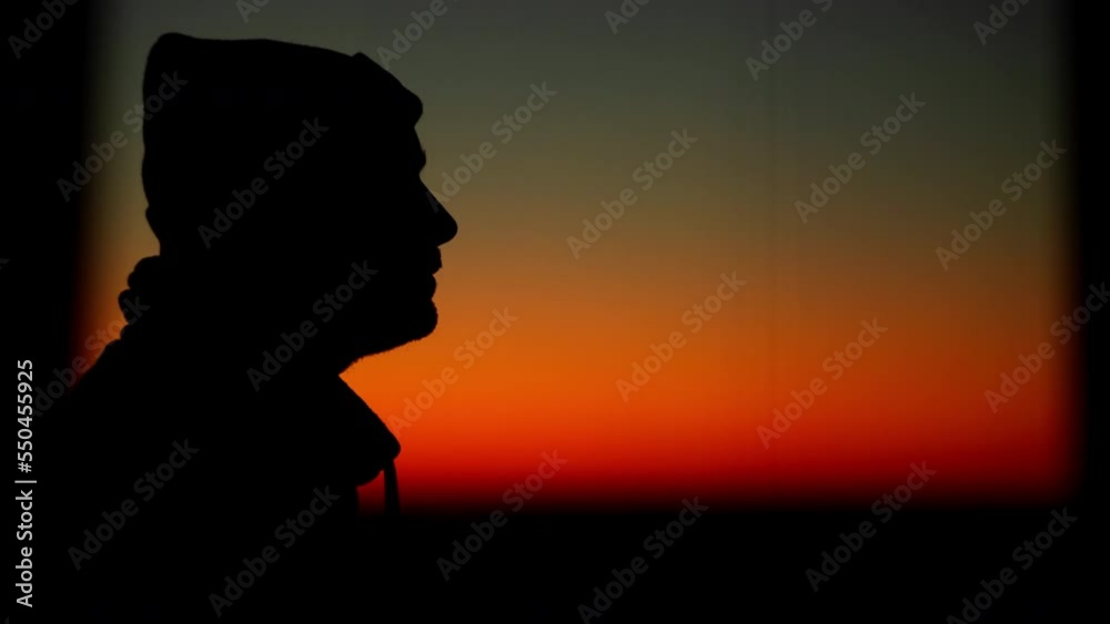 Silhouette of a man smoking a cigarette at sunset. Harmful habits of people that harm health. High quality 4k footage Silhouette of a man smoking a cigarette at sunset. Harmful habits of people that harm health. High quality 4k footage