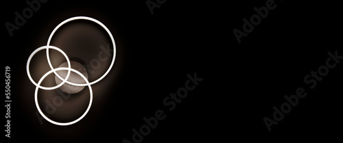 Chandelier luminous in the form of three rings against a black ceiling. Banner