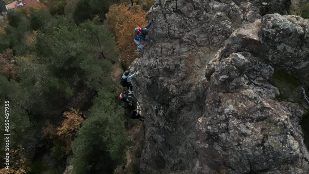 Aerial drone shot of group of climber climb up the cliff with beautiful view Aerial drone shot of group of climber climb up the cliff with beautiful view