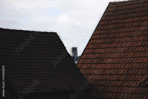 Church is visible from behind the houses of the roofs