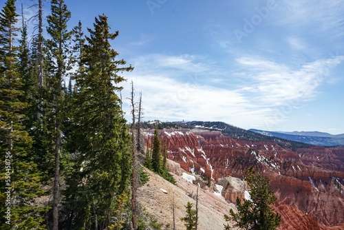 Red rocky hill on a sunny day with a cloudy blue sky photo