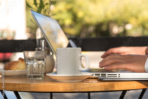 man outdoors working on his laptop