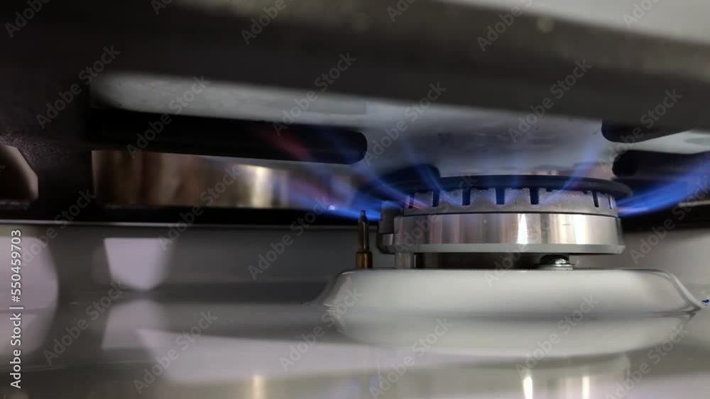 The saucepan is on the stove gas burner. Gas turns on and off. The furnace uses combustible or natural gas as fuel. energy crisis and rising energy prices