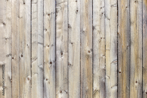 Vertical grey wooden background. Old grey wooden fence texture. Old wood texture background