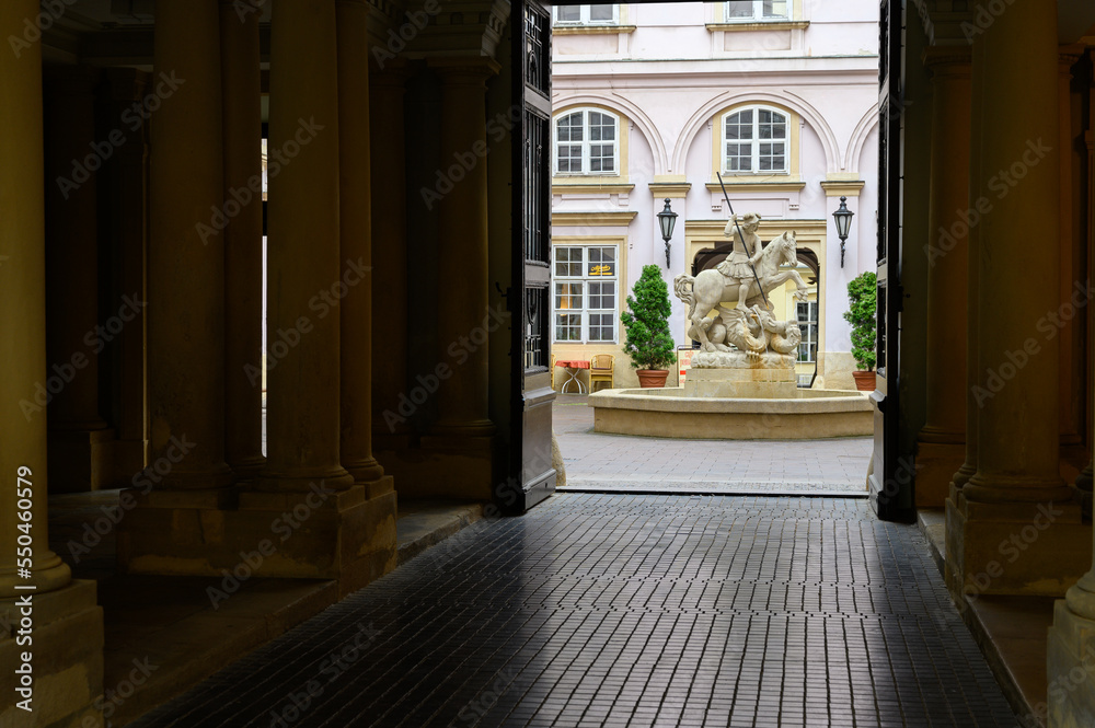 A fountain with a statue of Saint George fighting a dragon in the courtyard of Primate's Palace in Bratislava, Slovakia. 2021/05/27.