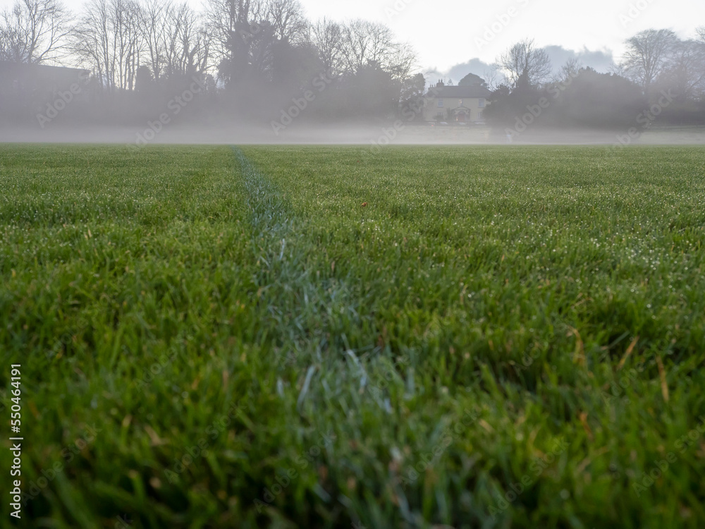 Obraz premium Irish National sport ground wit tall goal posts for camogie, hurling, rugby, Gaelic football at dusk and low fog over the ground. Calm and peaceful mood. Sport activity concept.