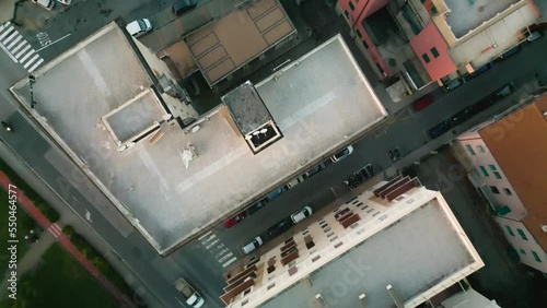 Aerial flight over rooftops in Sestri Levante. We see streets and city trafiic with cars. photo