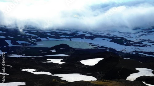 Walled lake and snowfields in the volcanic upheaval table area, near the Koryaksky volcano, volcanic topography. Kamchatka photo
