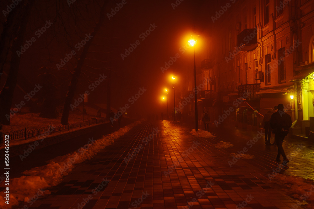 Night path with mystical red light. The city is in the fog. The effect of soft focus, sleep.