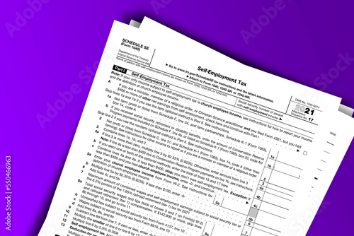 Form 1040 (Schedule SE) documentation published IRS USA 10.25.2021. American tax document on colored