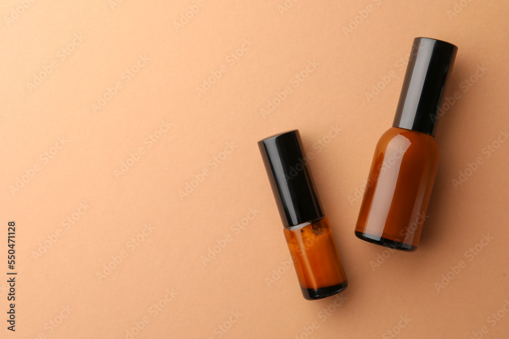 Bottles of face cream on beige background, flat lay. Space for text Bottles of face cream on beige background, flat lay. Space for text