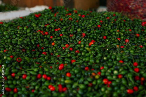 Heap of fresh delicious chiltepin on counter at market photo