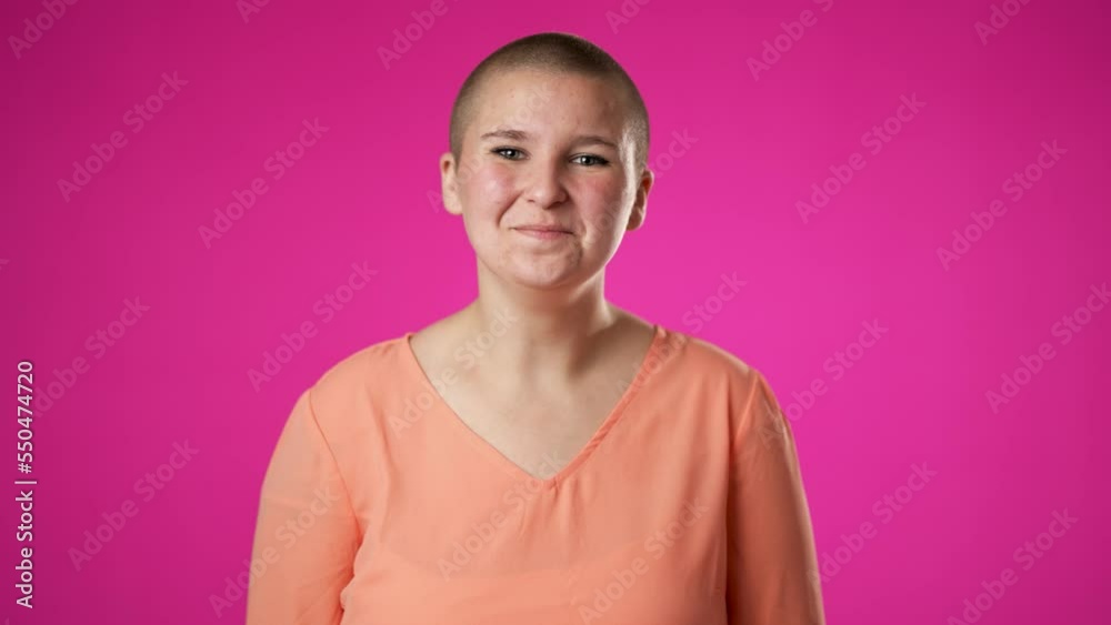 Gender fluid woman 20s look around for friend find waving meet greet with hand as notices someone, posing isolated on pink background studio. Portrait sincere emotions lifestyle concept. Gender fluid woman 20s look around for friend find waving meet greet with hand as notices someone, posing isolated on pink background studio. Portrait sincere emotions lifestyle concept.