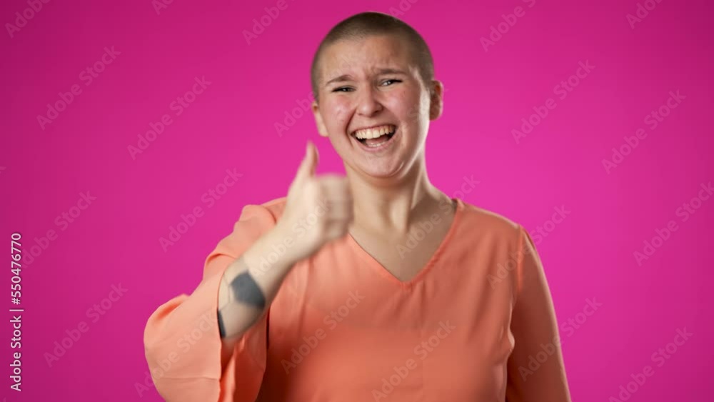 Portrait of gender fluid non binary young woman 20s years old posing isolated on pink background studio. Cover mouth with hands on face say wow omg no way Portrait of gender fluid non binary young woman 20s years old posing isolated on pink background studio. Cover mouth with hands on face say wow omg no way