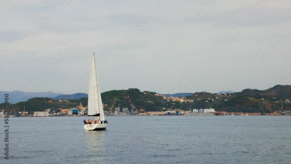 Around the sailing boat. Motor boat sails through the frame. Around the sailing boat. Motor boat sails through the frame.