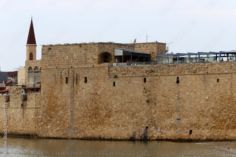 Stone wall of an ancient fortress on the seashore in Israel.