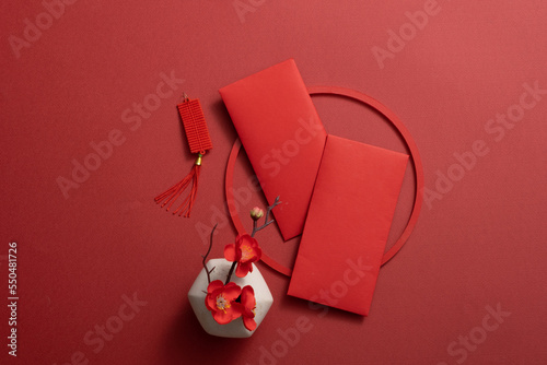 Fotografie Top view of lucky envelopes and decorative items for the Chinese lunar new year on a red background