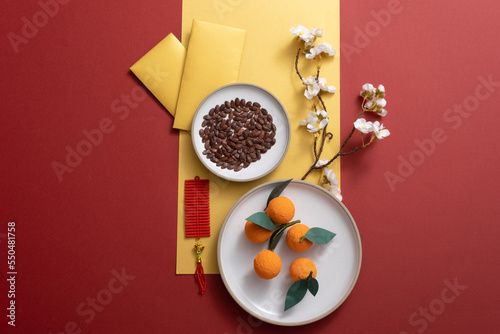 Chinese new year festival decorations with mandarin orange, nuts, flowers, and lucky money. Traditional festival in Asia