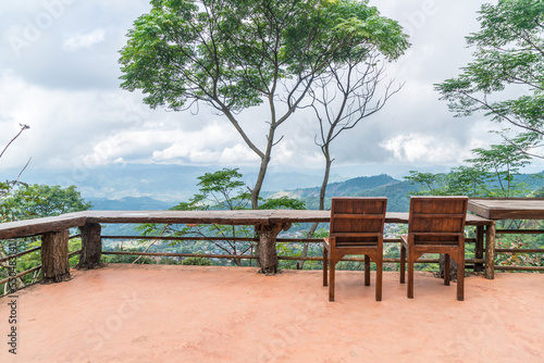 wood bar and chair with mountain hill background © topntp