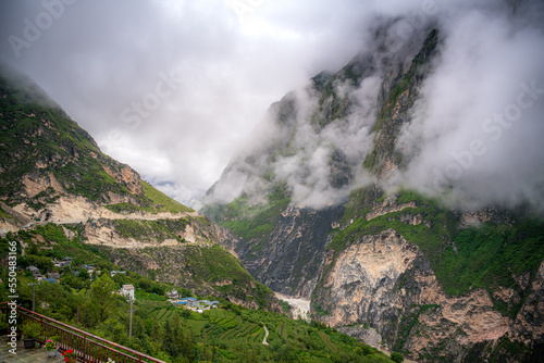 mountain village on tiger leaping gorge trek and the beautiful layer of the mountain after the rain in the clouds, Lijiang, China photo