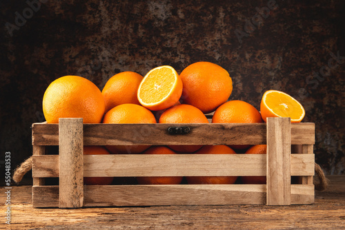 Fresh oranges in wooden box © Jakub