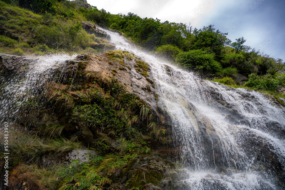 Fototapeta premium Beautiful waterfall along the trail at Tiger Leaping Gorge, Yunnan, China.