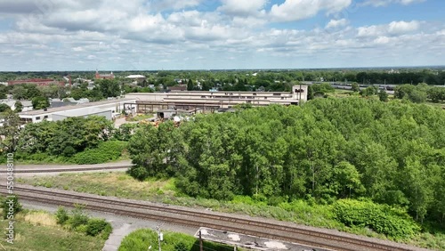 A panning aerial view of the Grand Central Railway Station yards and out buildings in Buffalo, New York.
