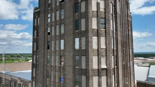 A ascending view of the architecture and brick front of the Grand Central Station in Buffalo, New York with the city in the background.