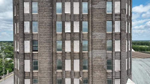 An ascending aerial view of the brick front and top of the Grand Central Station in Buffalo, New york.