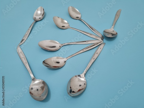 A collection of shiny silver spoons made of iron