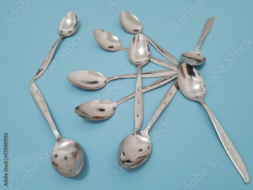 A collection of shiny silver spoons made of iron