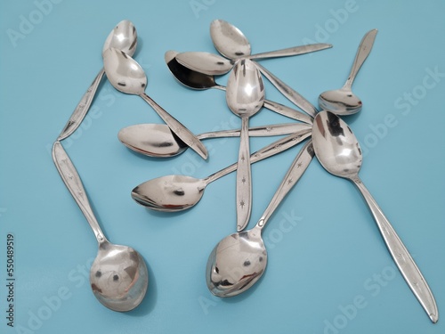 A collection of shiny silver spoons made of iron