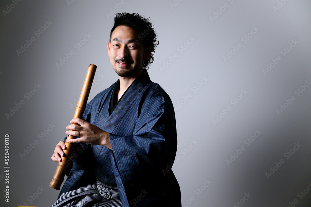 Middle-aged Japanese man playing 「shakuhachi」 Middle-aged Japanese man playing 「shakuhachi」