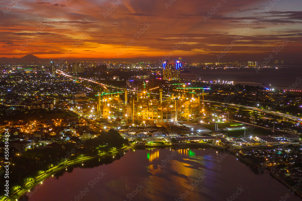 Glowing Jakarta International stadium at dusk