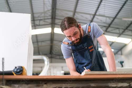 Carpenter working on the woodworking desk and furniture handmade with wood