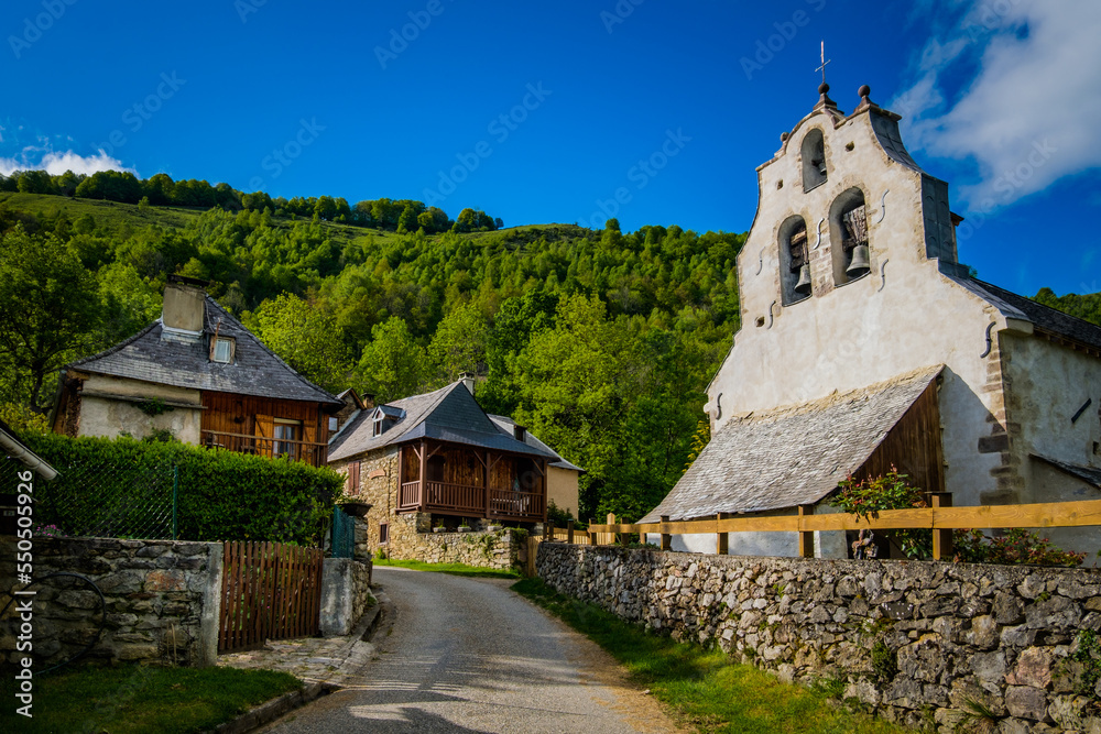 View on the old church and traditional houses in the village of Antras in the French Pyrenees mountains range