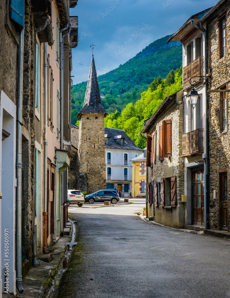 The street of the small village of Sentein with view on the church bell tower, in the French Pyrenees