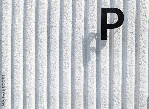 P text on white wall background  P stamp on the white wall  consonant P on the white wall.