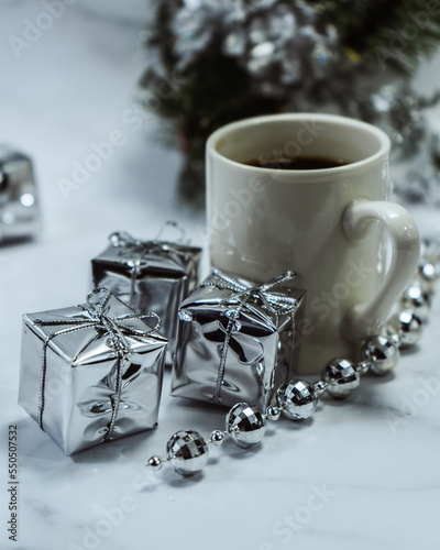 Christmas decorations on the table with a cup of coffee and an alarm clock. Christmas background. Merry Christmas greeting card  frame  banner. Space for text. Selective focus.