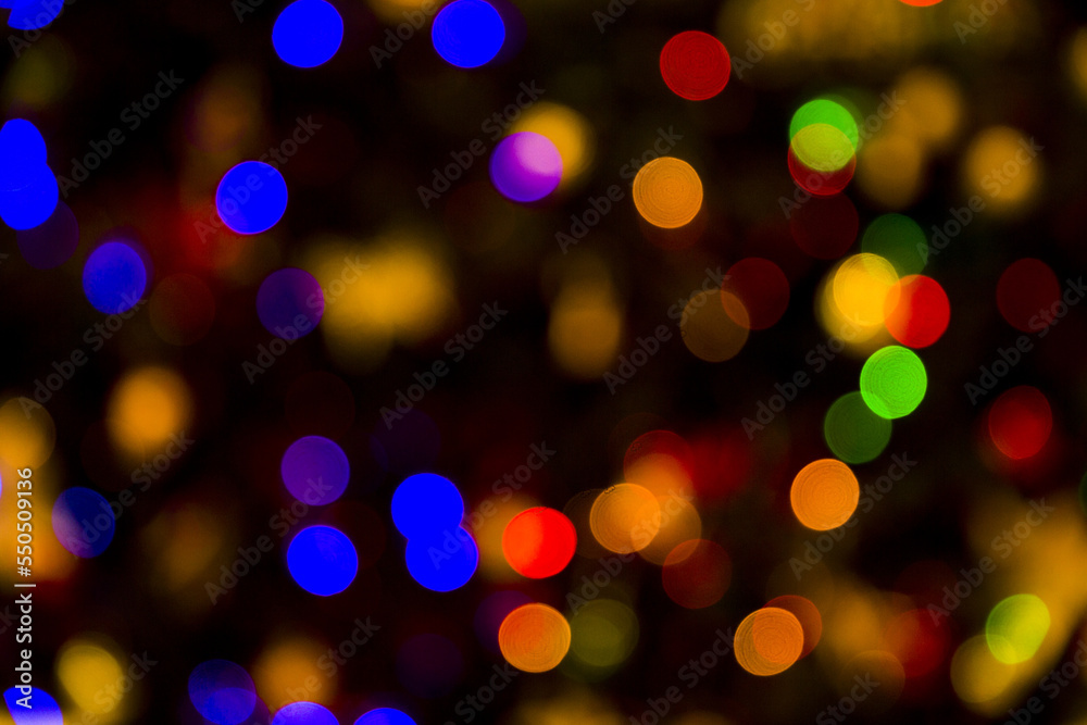 Colorful abstract bokeh lights Christmas background for your design.