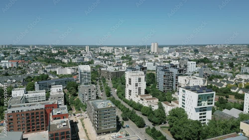 Drone flying over modern buildings of La Courrouze eco-district, Rennes city, Brittany in France. Aerial forward. Sky for copy space Drone flying over modern buildings of La Courrouze eco-district, Rennes city, Brittany in France. Aerial forward. Sky for copy space
