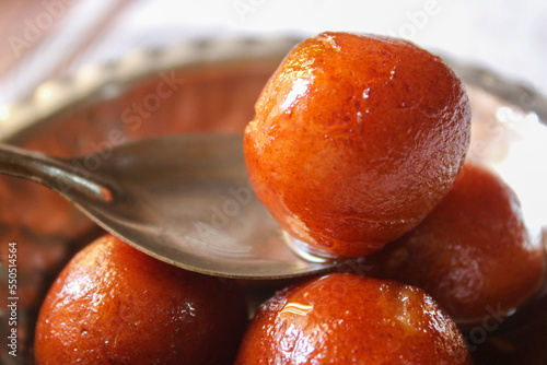Indian sweet food Gulab Jamun served in a steel bowl. indian sweet gulab jamun closeup view