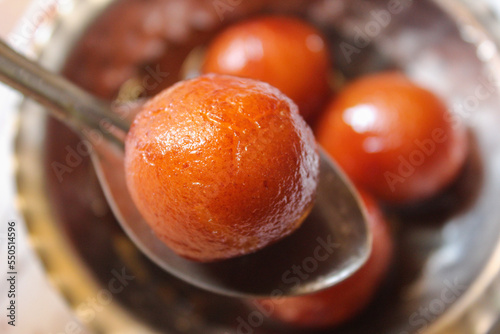 Indian sweet food Gulab Jamun served in a steel bowl. indian sweet gulab jamun closeup view photo