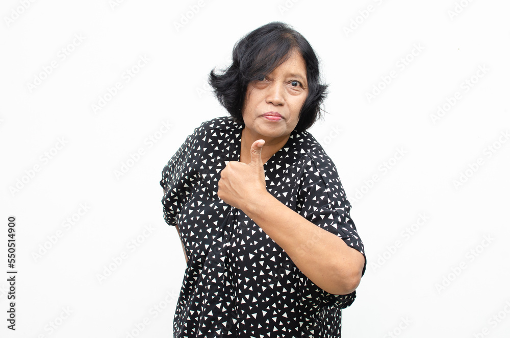 Portrait of happy ecstatic senior asian woman giving thumbs up and ok gesture as appreciation and approval Portrait of happy ecstatic senior asian woman giving thumbs up and ok gesture as appreciation and approval