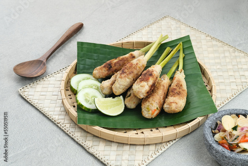 Sate Lilit, traditional Balinese minced chicken satay with lemongrass as skewer, served with sambal matah.
 photo