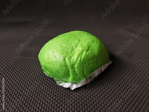 Green Bakpao.Asian steamed buns on wooden oval tray